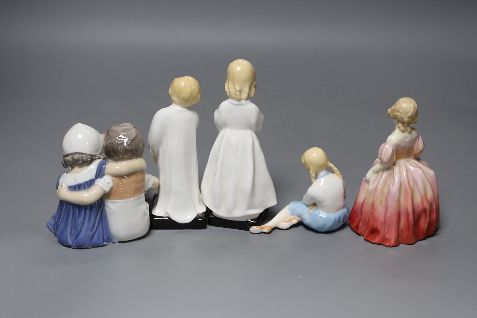 Four Royal Doulton figures and a Bing and Grondahl figure, tallest 16 cms high.